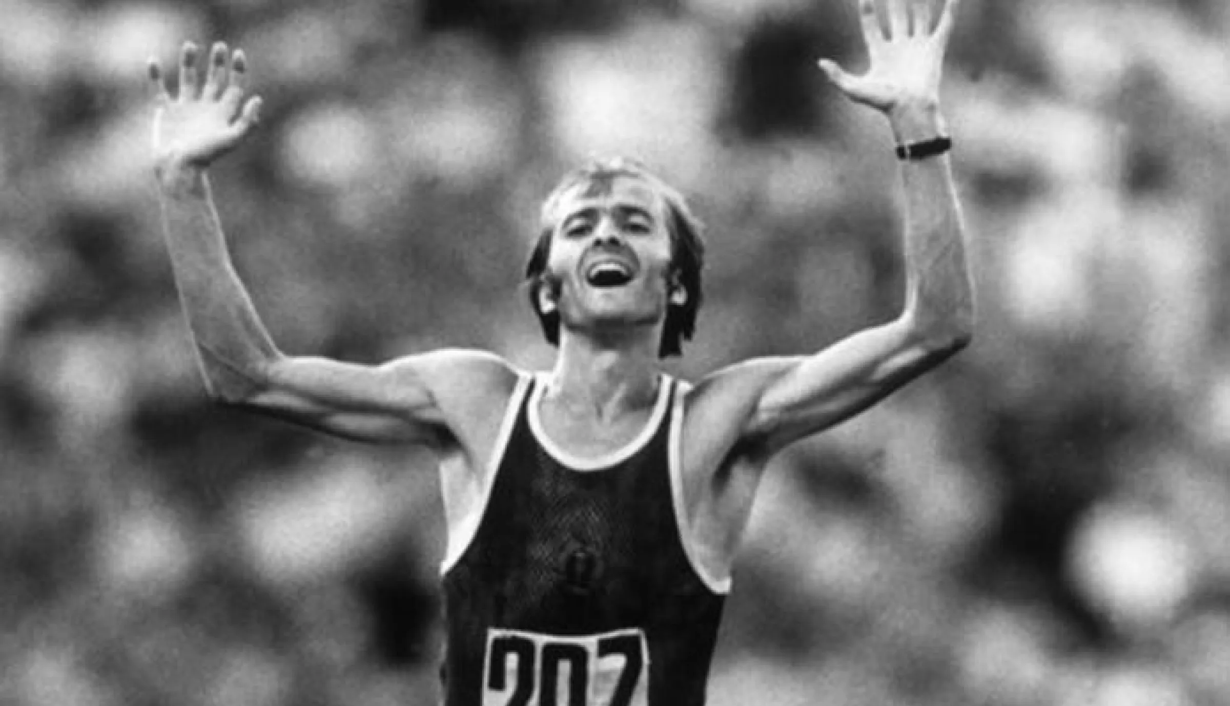 Schwarz-Weiß-Foto eines jungen Cierpinski im Jubel mit erhobenen Armen.